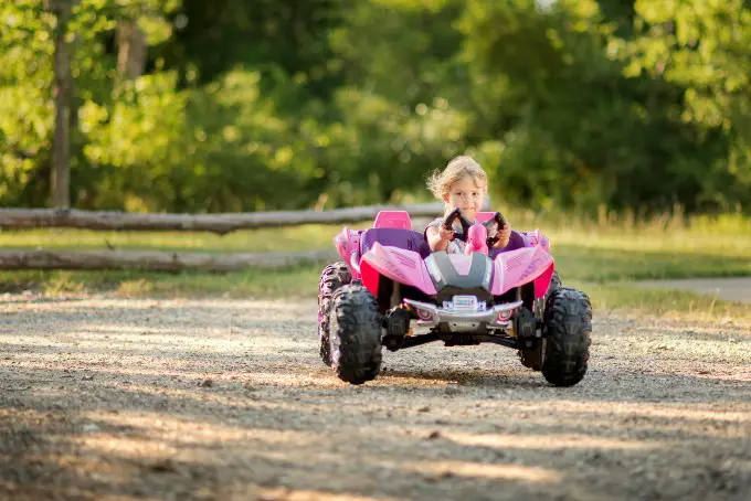 Girl rides Power Wheels