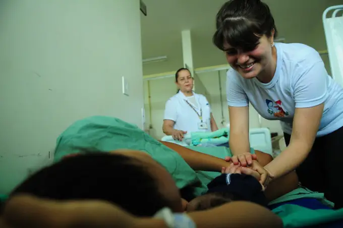 Doula checks on mother and baby